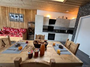 a living room with a wooden table and a couch at Appartement moderne à La Bresse, 2 chambres, accès PMR - FR-1-589-687 in La Bresse +22 photos