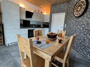 a kitchen with a wooden table with a bowl of food on it at Appartement moderne à La Bresse, 2 chambres, accès PMR - FR-1-589-687 in La Bresse