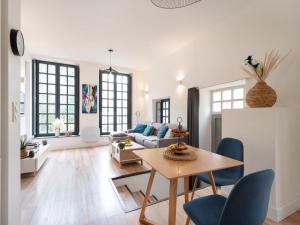 a living room with a couch and a table at Appartement moderne proche Place Stanislas - FR-1-584-349 in Nancy
