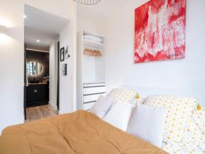 a bedroom with a bed and a painting on the wall at Appartement moderne proche Place Stanislas - FR-1-584-349 in Nancy