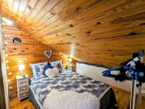 a bedroom with a bed with a wooden ceiling at Chalet familial Vosges avec baby-foot et animaux admis - FR-1-589-688 in Ventron