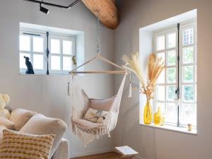 a room with a hammock hanging from a wall at Loft moderne au charme ancien, climatisé, près de la Place Stanislas - FR-1-584-352 in Nancy +1 photo