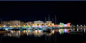 a group of boats in a harbor at night at La Corte Guest House in Bari