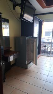 a kitchen with a refrigerator and a tile floor at Jomtien nighttrip hous in Jomtien Beach