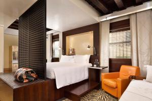 a hotel room with a bed and a chair at Ca' Pisani Hotel in Venice +37 photos