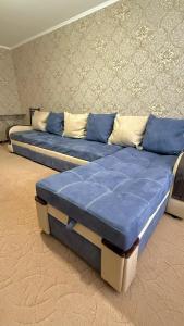 two beds with blue pillows in a room at 2х комнатная квартира на Толе би in Taraz