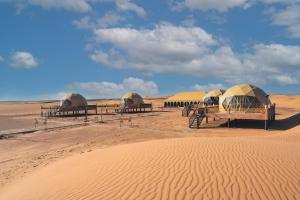 a group of tents in the middle of the desert at Sahara Dome Camp in Merzouga