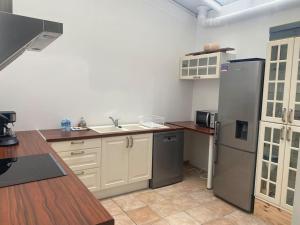 a kitchen with a refrigerator and a sink in it at Maison de 140m2 à 300m de la plage in Dunkerque +8 photos