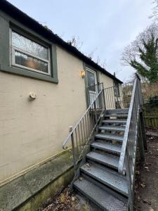 a set of stairs leading up to a house at New Road Apartment - 2 Bedrooms - Sleeps 3 in Whitehaven