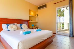 a bedroom with a bed with two teddy bears on it at Villa Bliss by Algarve Vacation in Praia do Carvoeiro +42 photos