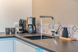 a kitchen counter top with a sink and a mixer at Villa Sailing-large luxury house in quiet location in Nieuwpoort