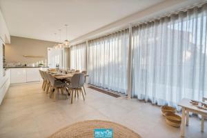 a dining room with a table and a large window at Villa Sailing-large luxury house in quiet location in Nieuwpoort
