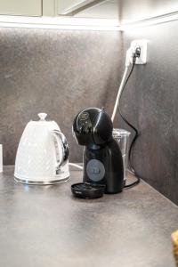une cafetière posée sur un comptoir à côté d'une prise électrique dans l'établissement Domeček Jasná, à Jeseník