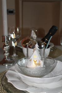 a table with a glass plate with a toy house on it at Charme Apartment St Tome in Almenno San Salvatore