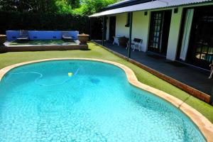 a swimming pool with a ball in the water at White Swan Guesthouse in Queenstown