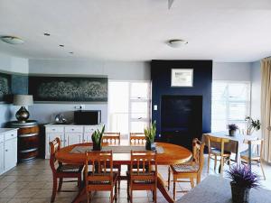 a kitchen and dining room with a table and chairs at Langebaan Beach Towers in Langebaan