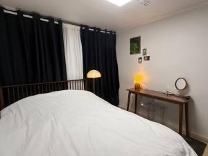 a bedroom with a bed and a desk and a window at KojjeeBnB Bed Room2, Qeen size bed2, TV 2, #KSPO#JYP#Hanriver in Seoul