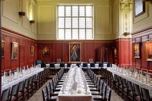 a large room with long tables and chairs in it at Sidney Sussex College, Cambridge in Cambridge