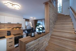 a staircase in a kitchen with wooden flooring at Chata Balux A in Liptovský Mikuláš +7 photos