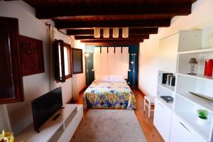 a bedroom with a bed and a flat screen tv at Rural Enjoy Cantabria in Arnuero
