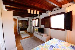 a bedroom with a bed and a television in it at Rural Enjoy Cantabria in Arnuero
