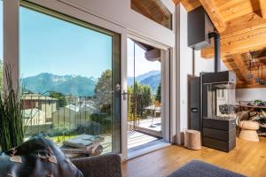 a living room with a large glass door with a view at BOTTONERA casa vacanza in Chiavenna