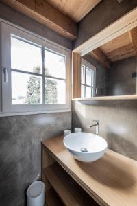 a bathroom with a sink and a window at BOTTONERA casa vacanza in Chiavenna +88 photos