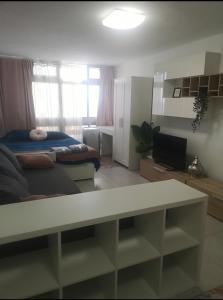 a room with a bed and a table in it at Estudio completo piscina y playa en Candelaria Tenerife in Candelaria +7 photos
