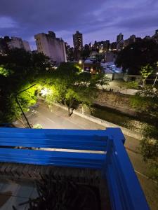 a blue bench in a city at night at En la cañada cerca de todo in Córdoba