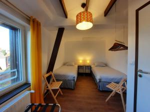 a room with two beds and a window at Le Petit Moulin Rouge, B&B, SDB en-suite, parking privé gratuit in Beauvoir +11 photos