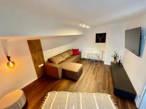 a living room with a couch and a table at Die Bergretter Appartements in Ramsau am Dachstein