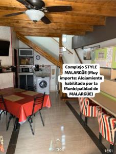 a dining room with a table and chairs and a ceiling at Alquiler por día en MALARGÜE muy céntrico in Malargüe