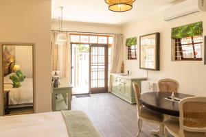 a kitchen and dining room with a table and a dining room at Mitre's Edge Simonsberg Studio in Klapmuts