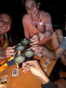 a group of people sitting around a table with tarot cards at Jungle life guesthouse Trekking & Transport Book with us in Bukit Lawang +62 photos