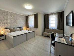 a bedroom with a bed and a living room at Camille Apartmanhouse in Budapest