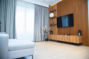a living room with a television on a wooden wall at The Pavilion 1BDR Luxury Apt in Accra