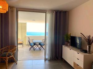 a living room with a view of the ocean at Appt Oceanne vue sur l'océan centre ville St Leu 5 min lagon in Saint-Leu