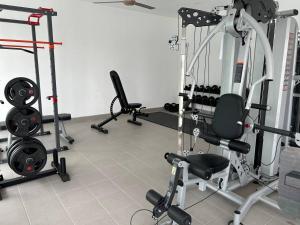 a gym with several treadmills and other equipment at Zanayra Homestay in Melaka