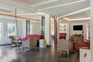 a living room with red couches and a tv at Sterling Wayanad in Sultan Bathery