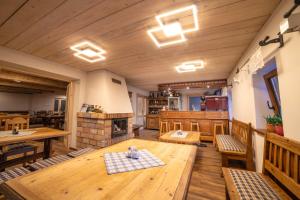 a large room with a wooden table and a fireplace at Koula Apartments in Pec pod Sněžkou