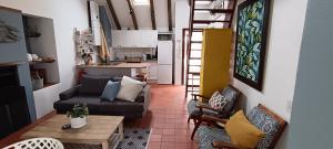 a living room with a couch and a table at River View Cottage - at the Breede in Witsand