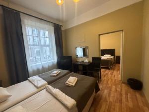 a hotel room with two beds and a mirror at Viktorija in Riga