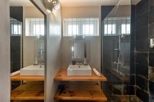 a bathroom with two sinks and a shower at Quaint 3 BDR Beach Bungalow in a fishing village in Grand Gaube +43 photos