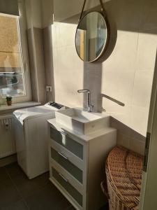 a bathroom with a sink and a mirror at City Villé Ferienwohnung Innenstadt in Neubrandenburg
