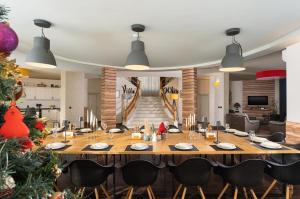 a dining room with a large table and a christmas tree at Вила Франк/Villa Frank in Enina