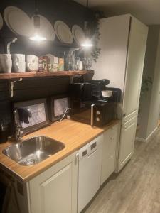 a kitchen with a sink and a counter at Stockholms home away from home in Stockholm