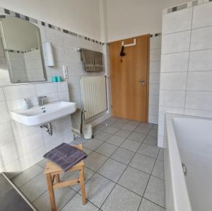 a bathroom with a sink and a toilet and a mirror at Ferienwohnung Mit Herz in Diez +23 photos