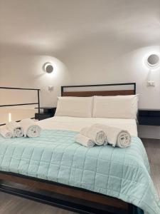 a bedroom with a bed with towels on it at Luxury apartment - La fenice in Bari +16 photos
