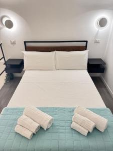 a bedroom with a bed with two towels on it at Luxury apartment - La fenice in Bari