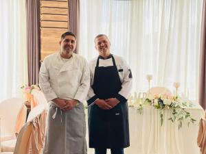 two chefs standing next to each other in a room at Вила Франк/Villa Frank in Enina